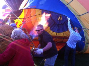 Holding open the throat of a hot air balloon as the envelope fills with hot air